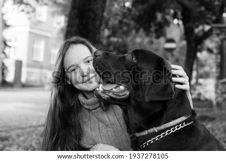 Similar – Portrait of a young, tall woman behind a blond Labrador