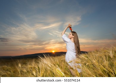 Portrait of girl in wheat field during sunset - Shutterstock ID 551074114