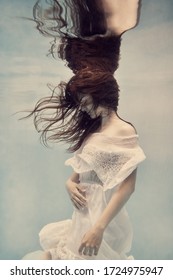     Portrait of a girl in a white dress underwater                           