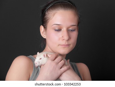 portrait of the girl with a white rat in hands