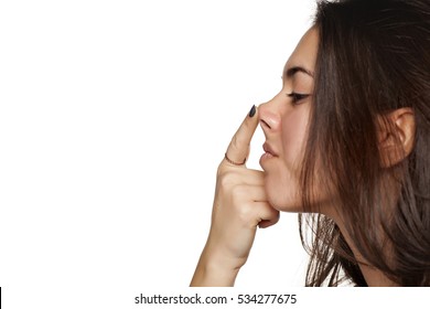 portrait of a girl who raises her nose with a finger
