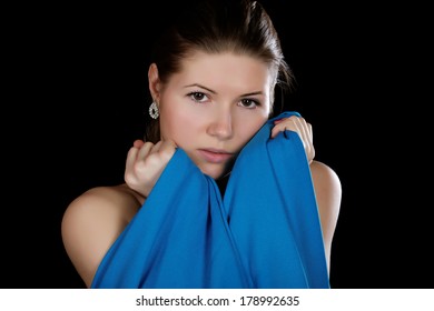 Portrait Of The Girl  Wrapped Up Dark Blue Fabric On A Black Background