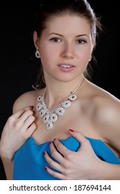 Portrait Of The Girl  Wrapped Up Dark Blue Fabric On A Black Background