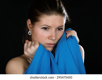 Portrait Of The Girl  Wrapped Up Dark Blue Fabric On A Black Background