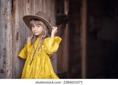 Portrait of girl in yellow dress and brown hat on brown background - Powered by Shutterstock