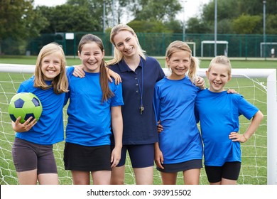 Portrait Of Girl's Soccer Team With Coach