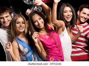 Portrait of glad teens looking at camera with smiles during party - Powered by Shutterstock