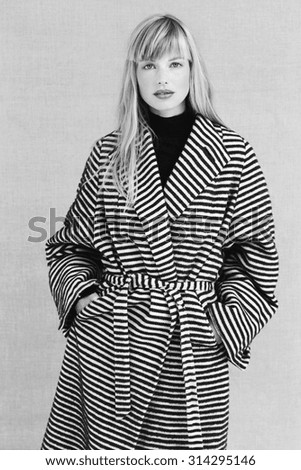 Portrait of glamorous woman in striped coat