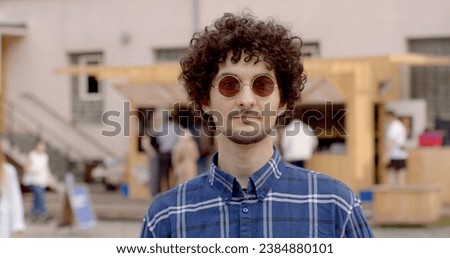 Portrait glass man posing in urban location revealing sense of confidence self-assuredness. Modern city vibrant backdrop youthful presence Lifestyle Portrait of young man in urban environment. 