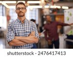 Portrait, glasses and business man with arms crossed in startup office for pride in career or job. Creative, face and confident professional entrepreneur, copywriter and employee coworking at company