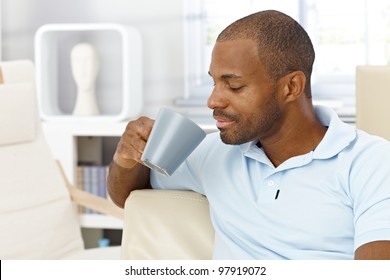 Portrait Of Goodlooking Black Man Enjoying Coffee At Home, Mug Handheld.