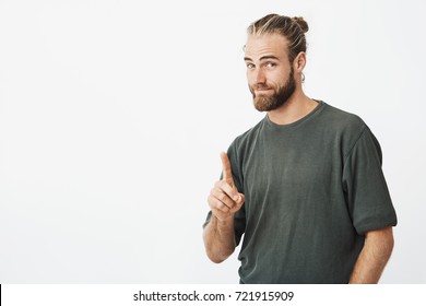 Portrait Of Good-looking Nordic Man Showing Index Finger Asking To Wait For A Minute While He Clean Hands In Toilet. Body Language.