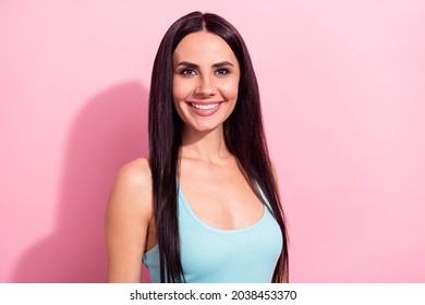Portrait of gorgeous cheerful long-haired girl wearing mint tanktop isolated over pink pastel color background