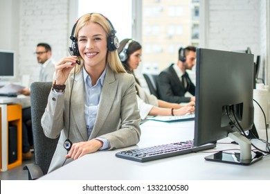 Portrait of a gorgeous customer service representative woman with headset in office