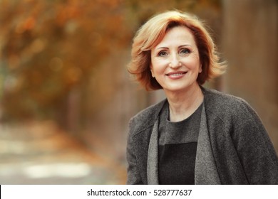 Portrait Of Gorgeous Middle Aged Woman In Autumn Park