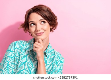 Portrait of gorgeous minded person hand touch chin look interested empty space isolated on pink color background