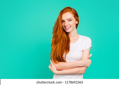 Portrait of gorgeous, nice, stunning, adorable, good-looking young girl in white polo with long hair hug herself and smile, stand isolated on pastel teal background with copy space for text