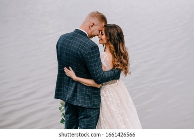 Portrait Of Gorgeous Wedding Couple Near Lake