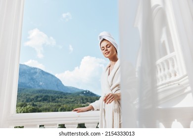Portrait of gorgeous woman posing against the backdrop of mountains on the balcony architecture Relaxation concept