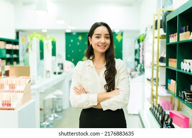 Portrait of a gorgeous woman and salesperson feeling happy while working at the makeup shop 