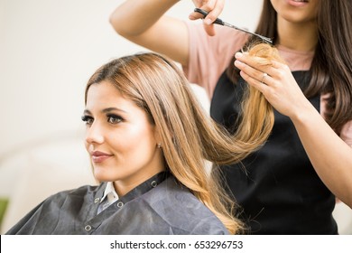 Portrait Of A Gorgeous Young Blonde Getting Her Hair Cut By A Hairstylist At A Beauty Salon