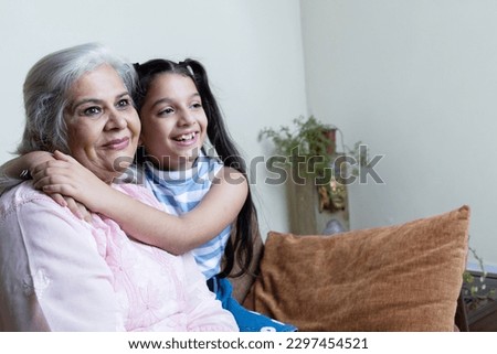 Portrait of grand daughter  hug  and  Grand daughter in living room.