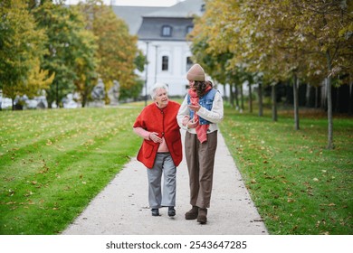 Portrait of a granddaughter on an autumn walk in the park with her grandmother. - Powered by Shutterstock