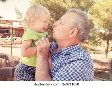 Portrait Of Grandfather With Little Cute Girl Having Fun On Nature In Summer. Happy Family Life Concept. 