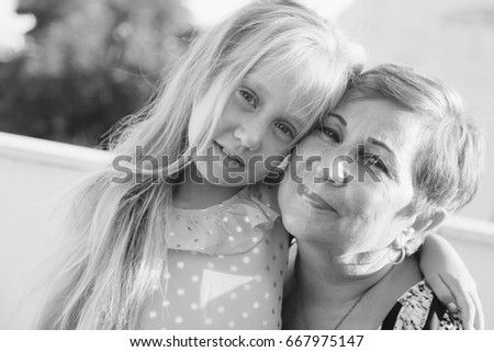 Similar – Granddaughter hugging her grandmother