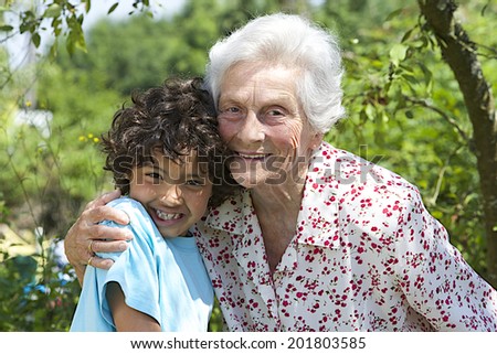 Similar – Grandma cuddles up with her grandson