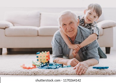 Portrait Grandpa And Grandson Playing With Toys. Family Relationship Between Grandfather And Grandson. Grandpa Teaching, Male Grandchild, Learning Concept. Relations And People Concept.