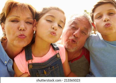 Portrait Of Grandparents And Grandchildren In Garden