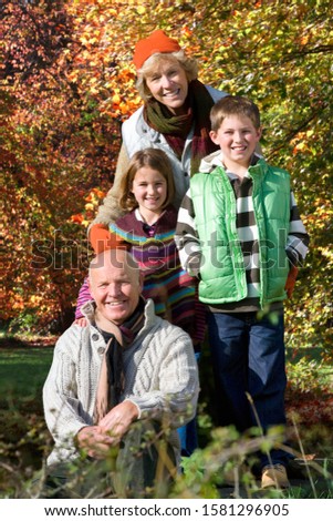 Similar – Grandfather and grandchildren exercise on a fitness facility in the park