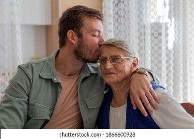 Portrait of the grandson kissing a grandmom. 
