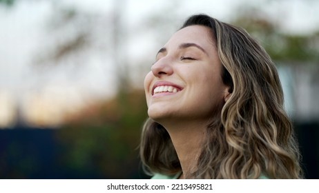 Portrait of a grateful contemplative young woman closeup face. Meditative 20s girl opening eyes to sky with gratitude - Shutterstock ID 2213495821