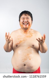 Portrait Of A Greedy And Dirty Fat Man With Tomato Sauce Spreading On His Body In White Background.Unhealthy Concept.