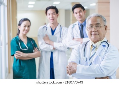 Portrait Group of Asian doctor and nurse crossing arm with smiling. Professional medical team standing in hospital office ward and giving encouragement to patient people after work in recovery room. - Powered by Shutterstock