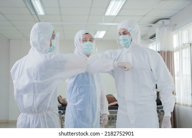 Portrait Group Of Asian Doctor And Nurse Elbow Bump Together With Smile. Professional Medical Team Stand In Hospital Office Ward And Giving Encouragement To Patient People After Work In Recovery Room.