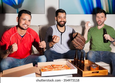 Portrait Of A Group Of Baseball Fans And Friends Watching A Game On TV At Night And Feeling Excited