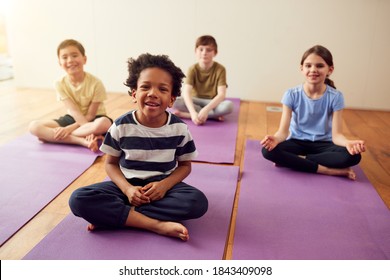 Portrait Of Group Of Children Sitting On Exercise Mats In Exercise Class - Powered by Shutterstock