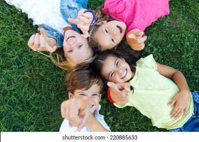 Portrait Of Group Of Childrens Having Fun In The Park.