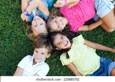 Portrait Of Group Of Childrens Having Fun In The Park.