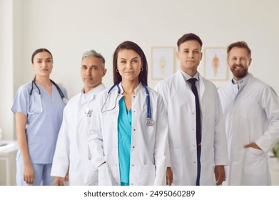 Portrait of a group of confident handsome doctors at their workplace. Medical practice in a hospital. Professional team of gastroentorology clinic. Friendly staff, successful medicine - Powered by Shutterstock