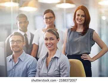 Portrait Of A Group Of A Diverse Corporate Group Standing In An Office. Happy Smiling Colleagues Motivated And Dedicated To Success. Cheerful And Ambitious Team Working Together In A Startup Agency