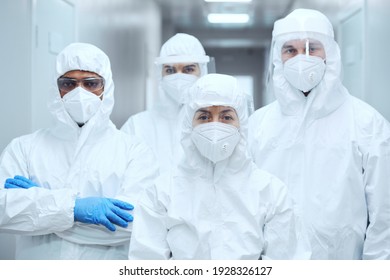 Portrait of group of doctors in uniforms looking at camera while working at hospital during pandemic - Powered by Shutterstock