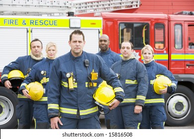 Portrait Of A Group Of Firefighters By A Fire Engine