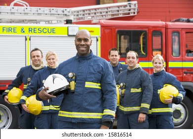 Portrait Of A Group Of Firefighters By A Fire Engine