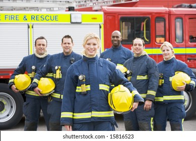 Portrait Of A Group Of Firefighters By A Fire Engine