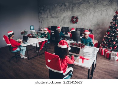 Portrait of group friends colleagues working desktop laptop computer christmas party loft office indoors - Powered by Shutterstock