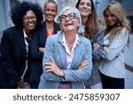 Portrait group of multiracial and diverse ages smiling business only women in formal suit. Cheerful businesswomen looking laughing at camera outdoor. Empowered, successful, professional female worker